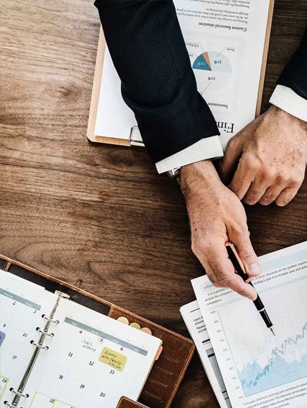 Accounting and Tax: accountant reviewing financial reports and a calculator at a desk