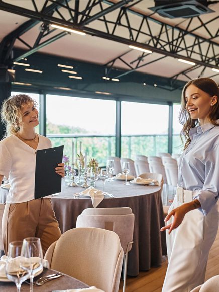 Events and Planning: event planners preparing a dining room for a reception