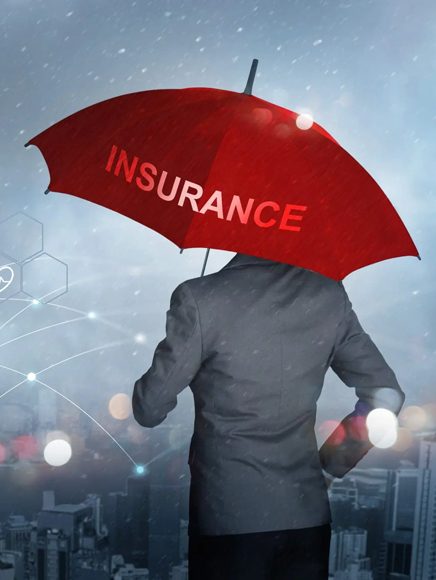Insurance and Coverage: person sheltered by a red umbrella representing insurance coverage