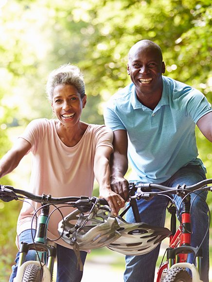 Leisure and Recreation: smiling couple out for a bike ride in the park