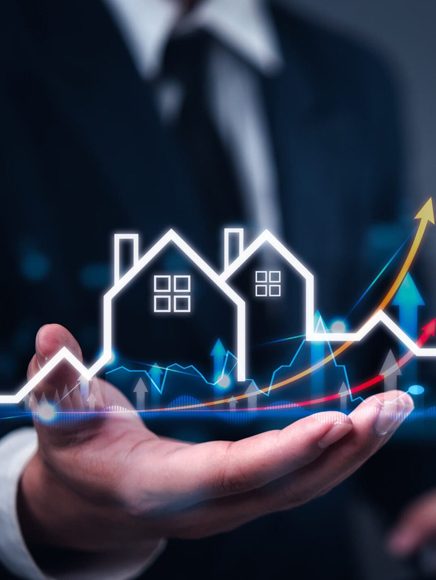 Real Estate: hand holding small house icons and a rising price chart