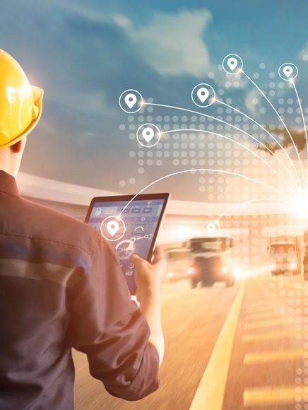 Transportation and Logistics: logistics worker tracking delivery routes on a tablet